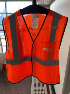 Photo of orange safety vest printed with AL branding