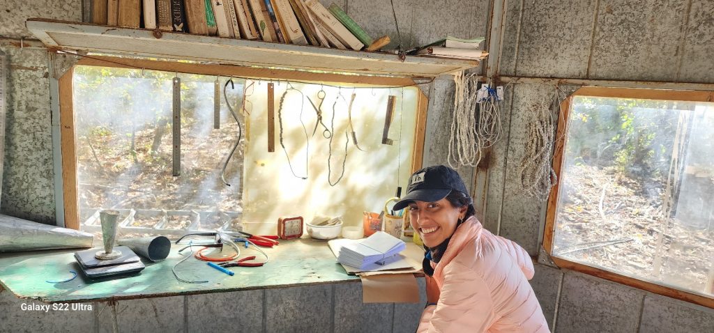 Photograph of Nicole working inside the Chokpak ornithological station during the fall bird migration.