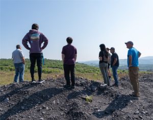 Photo of student interns on a field trip to a wind generation facility.